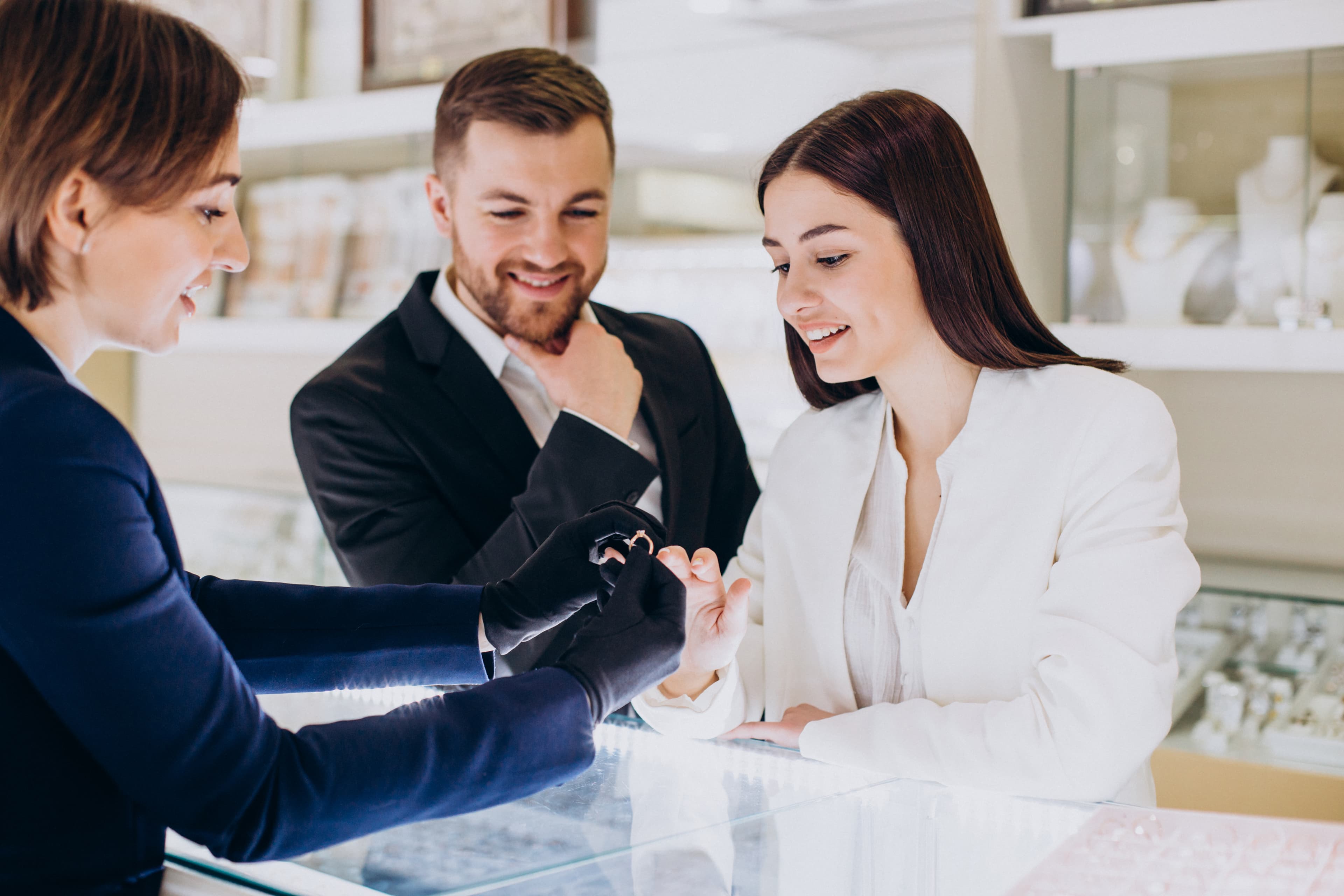 Young couple choosing jewelry at jewelry shop