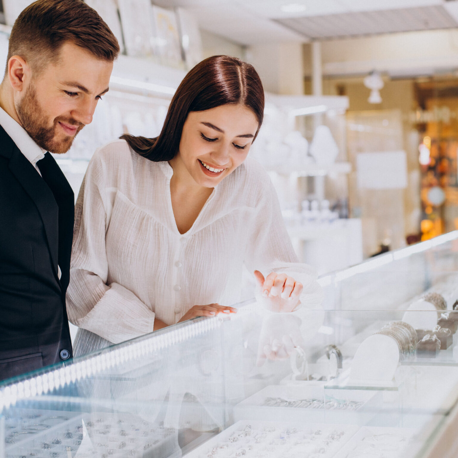 Young couple choosing jewelry at jewelry shop